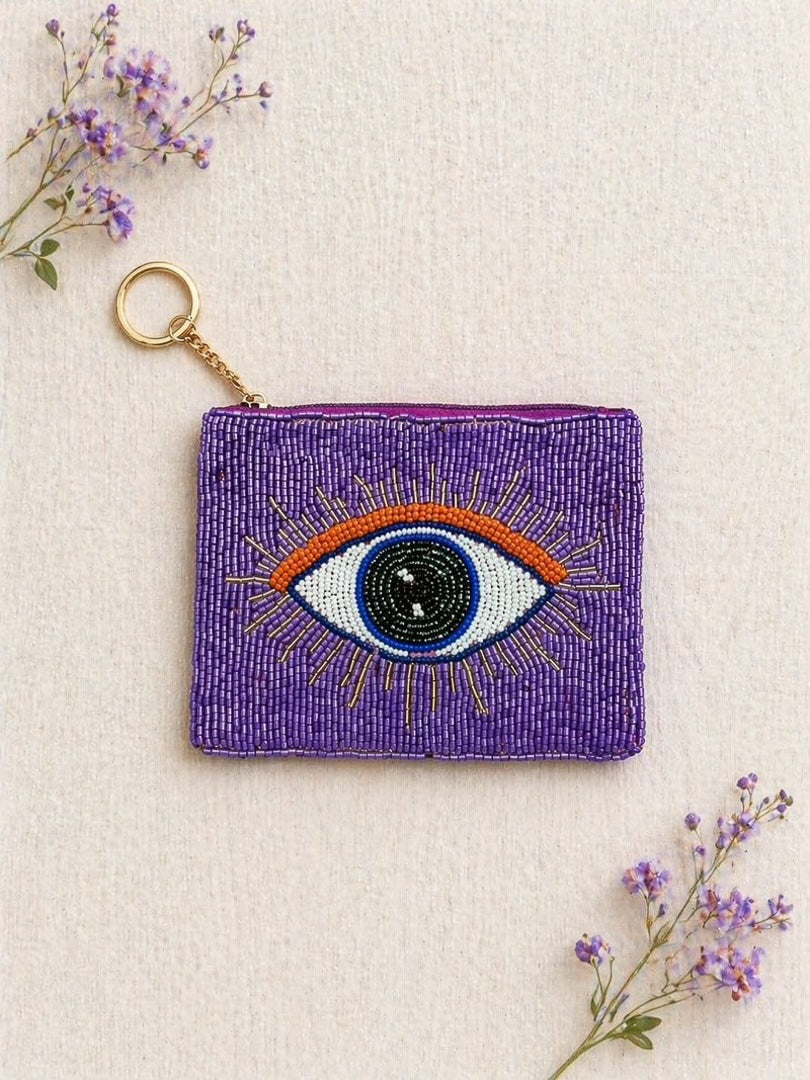 Porte-monnaie avec son anneau, sa chaînette dorée et son motif oeil violet